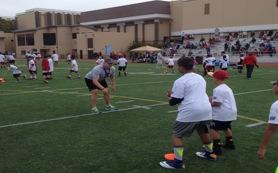 Sophomore Linebacker Nick Kosik demonstrates to a group on ball handling.