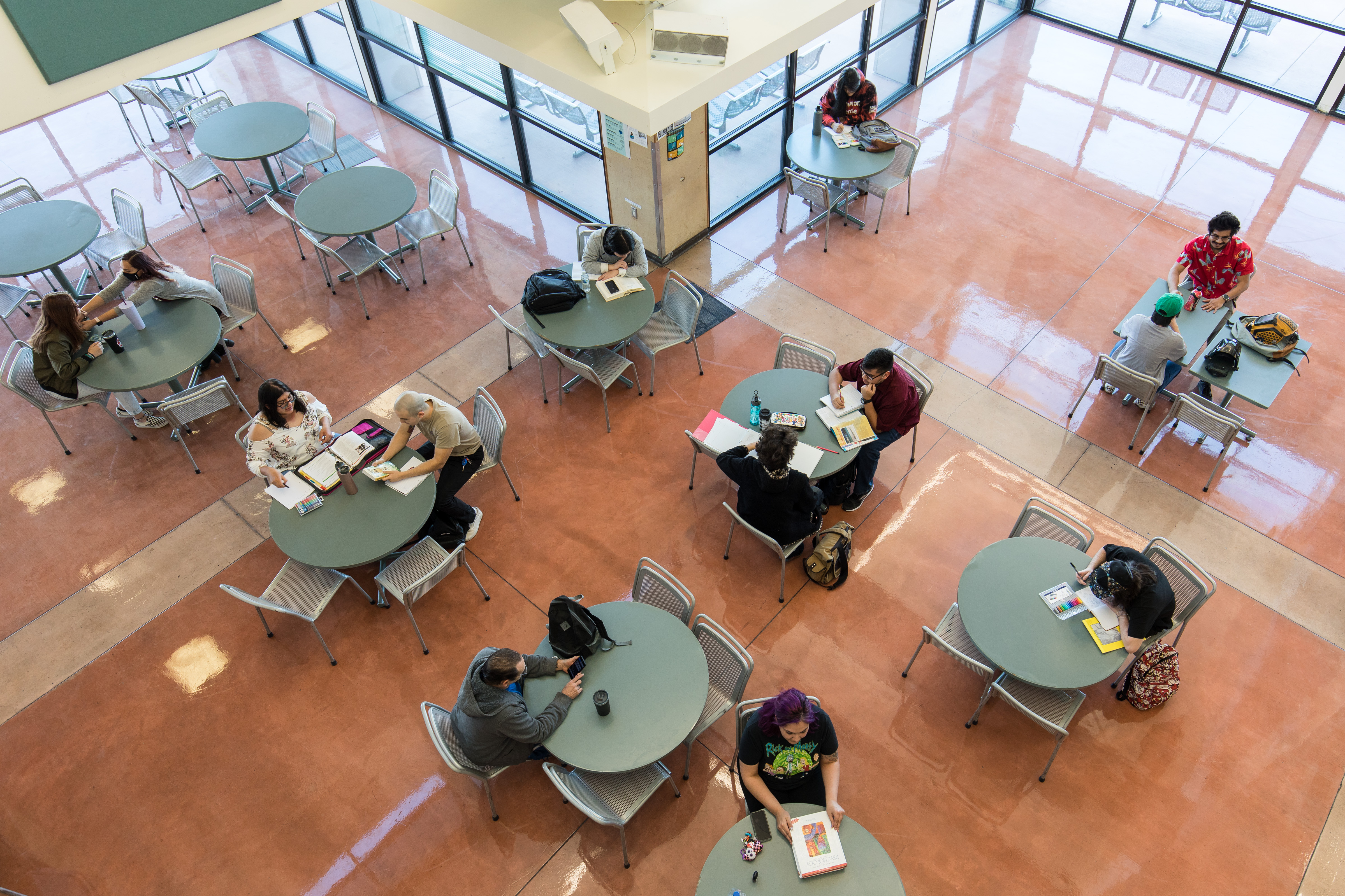 Photo taken from 2nd story of students studying at round tables in the Student Activities Center at VVC.