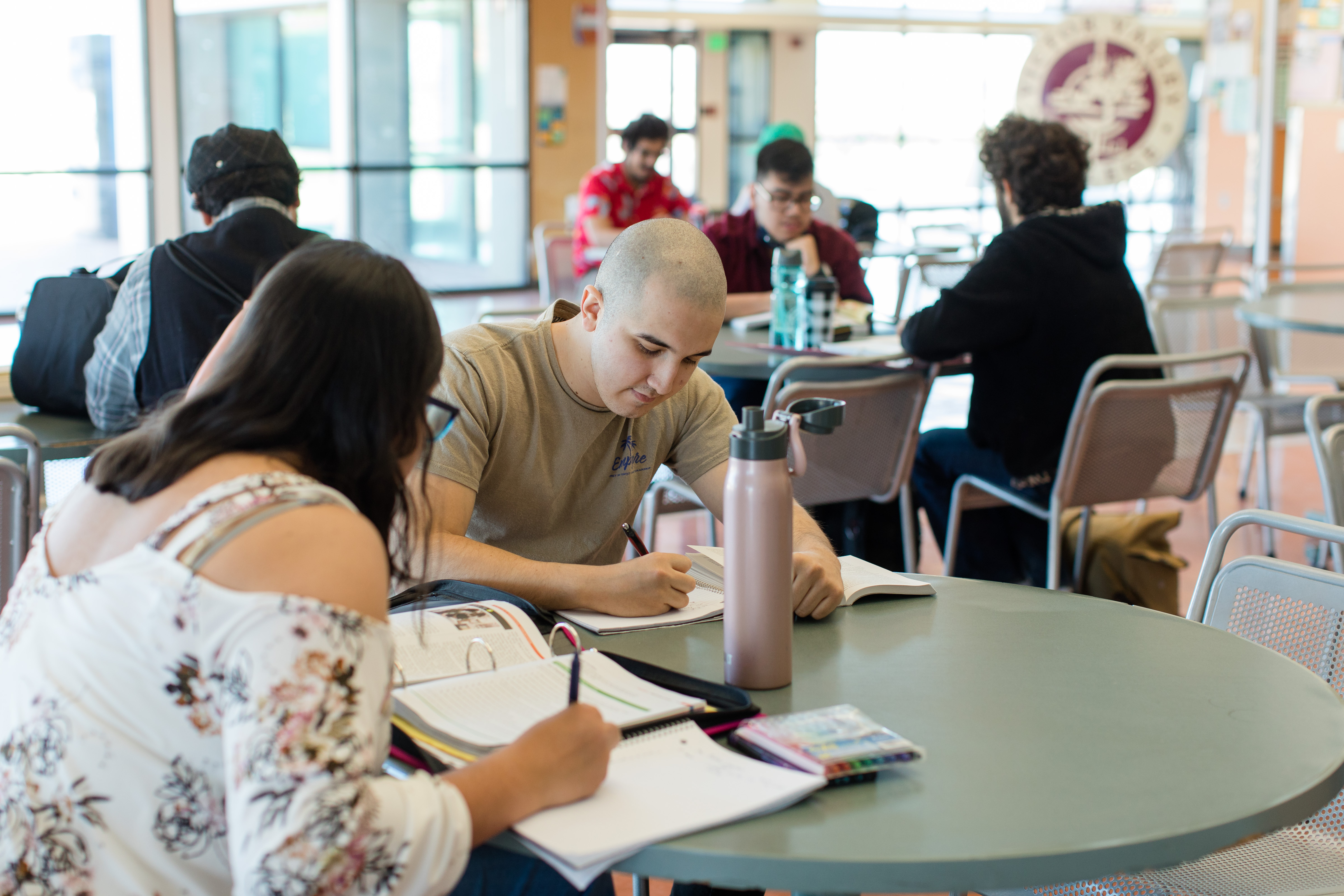 Two students studying in at a round table in the Associated Students building.