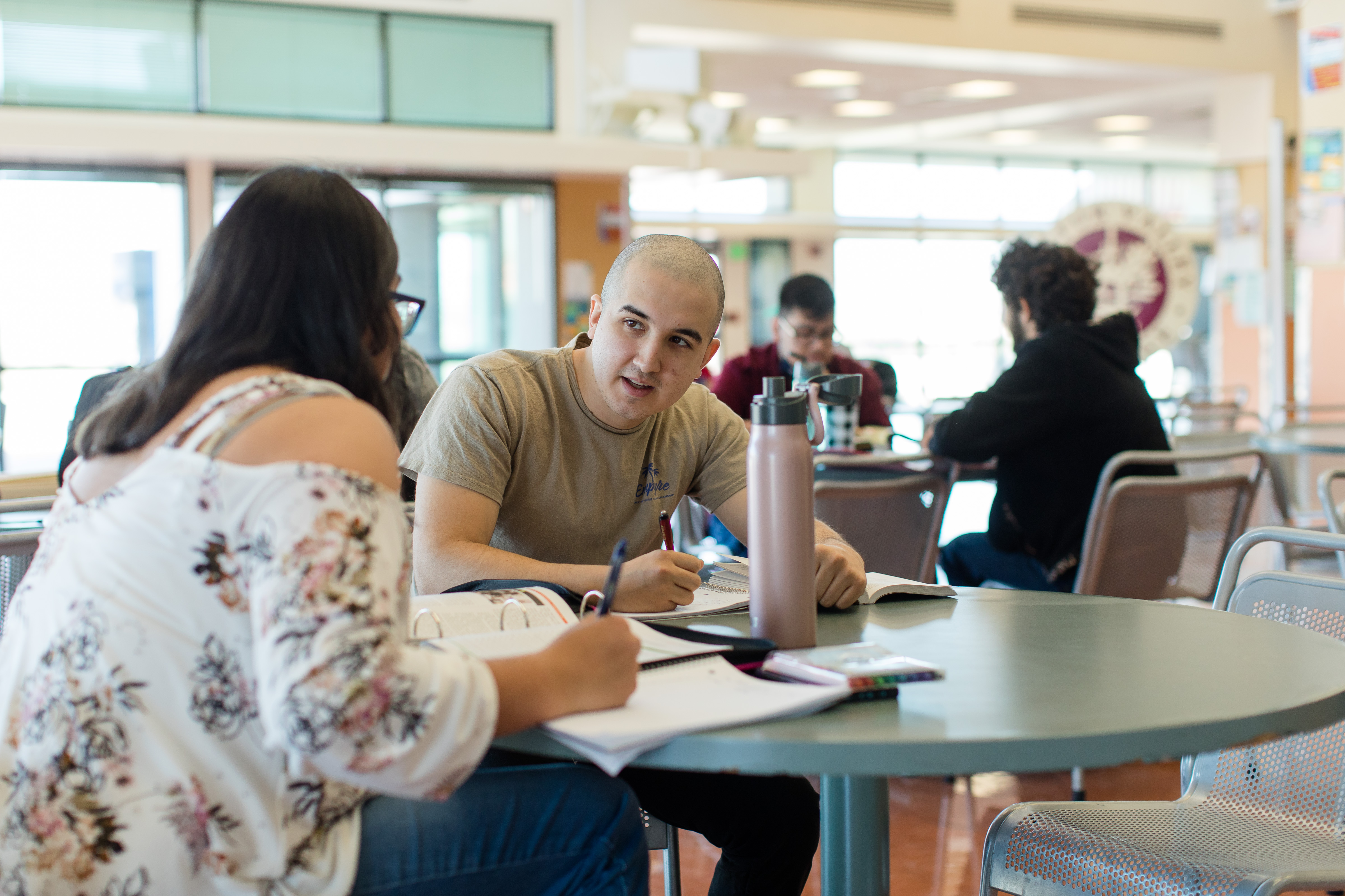 2 students doing homework at a table