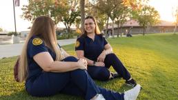 Two students talking on the lawn